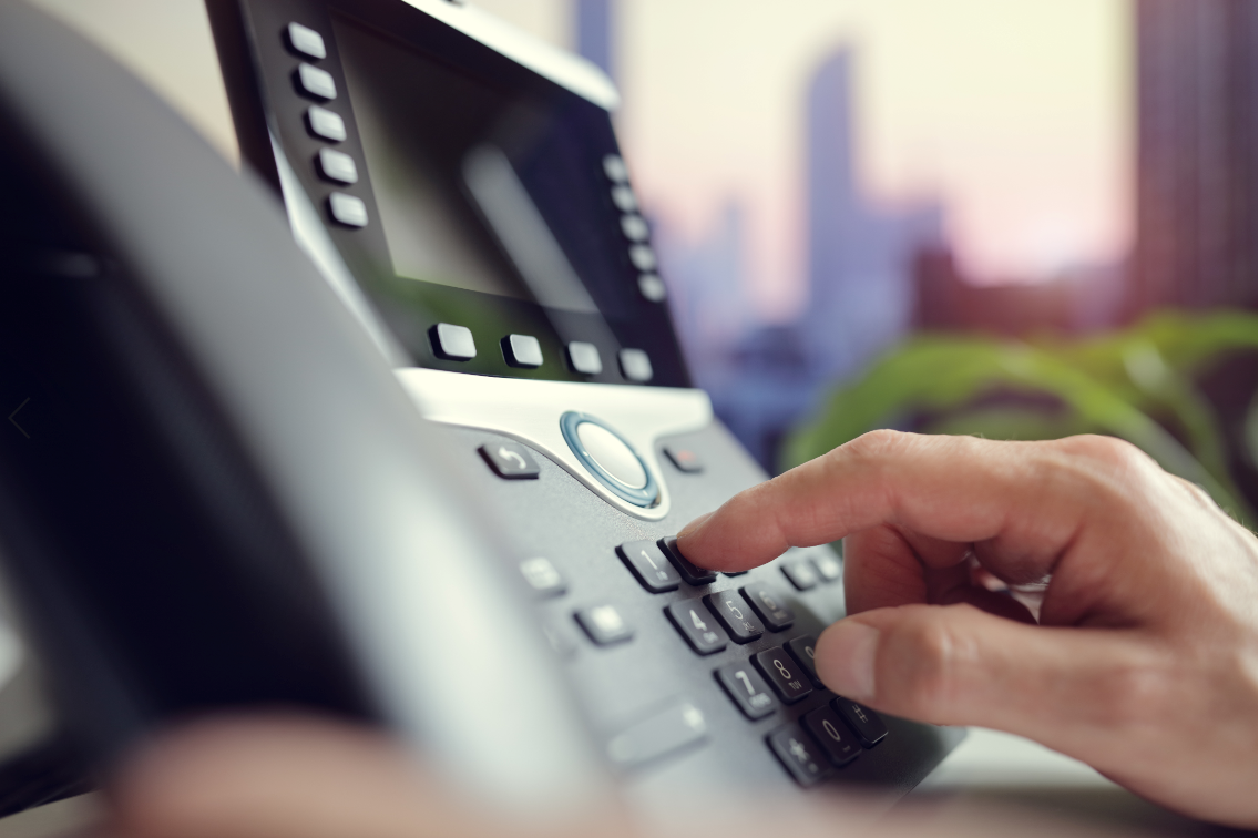 Hand dialling number on a landline telephone