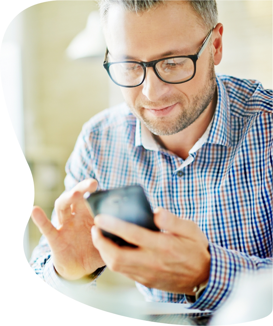 Man with glasses looking at a phone