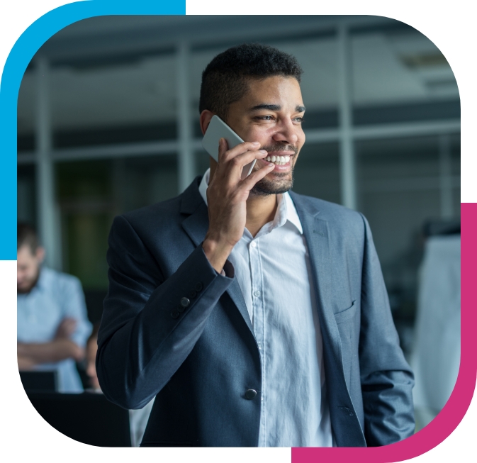 management Smart looking man on a phone leaning on a wall