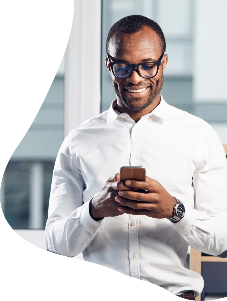 Man in white shirt typing on a phone