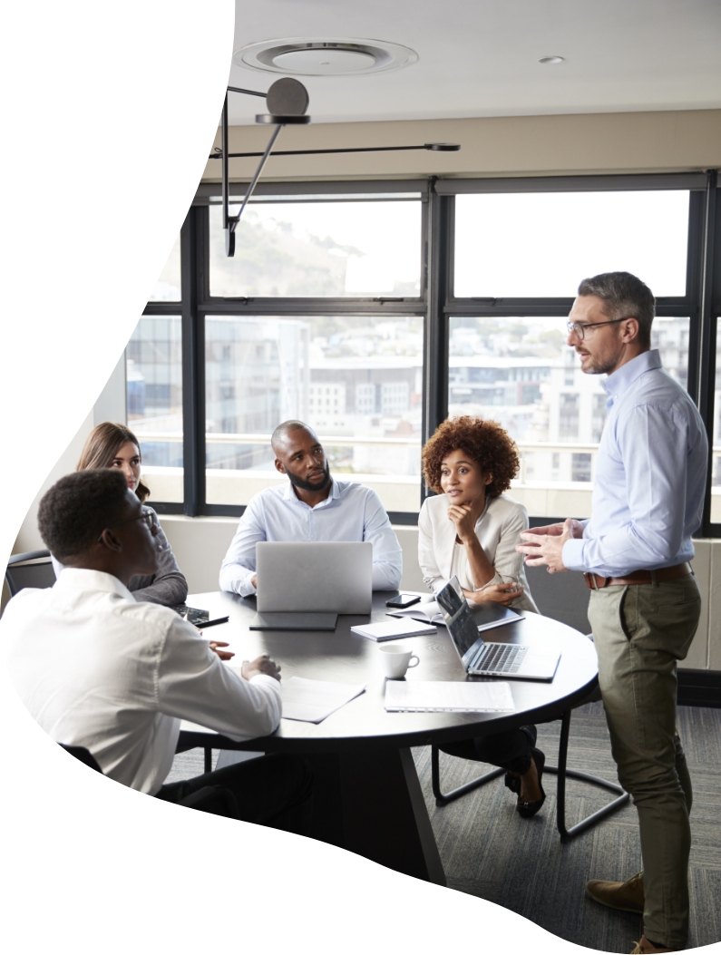 Team of co-workers talking to each other in an office environment